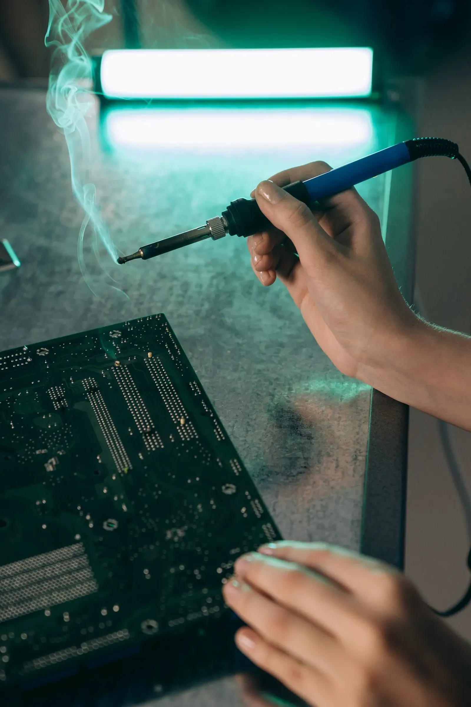 Circuit board being repaired at component level in the Fisher Scales workshop Attleborough